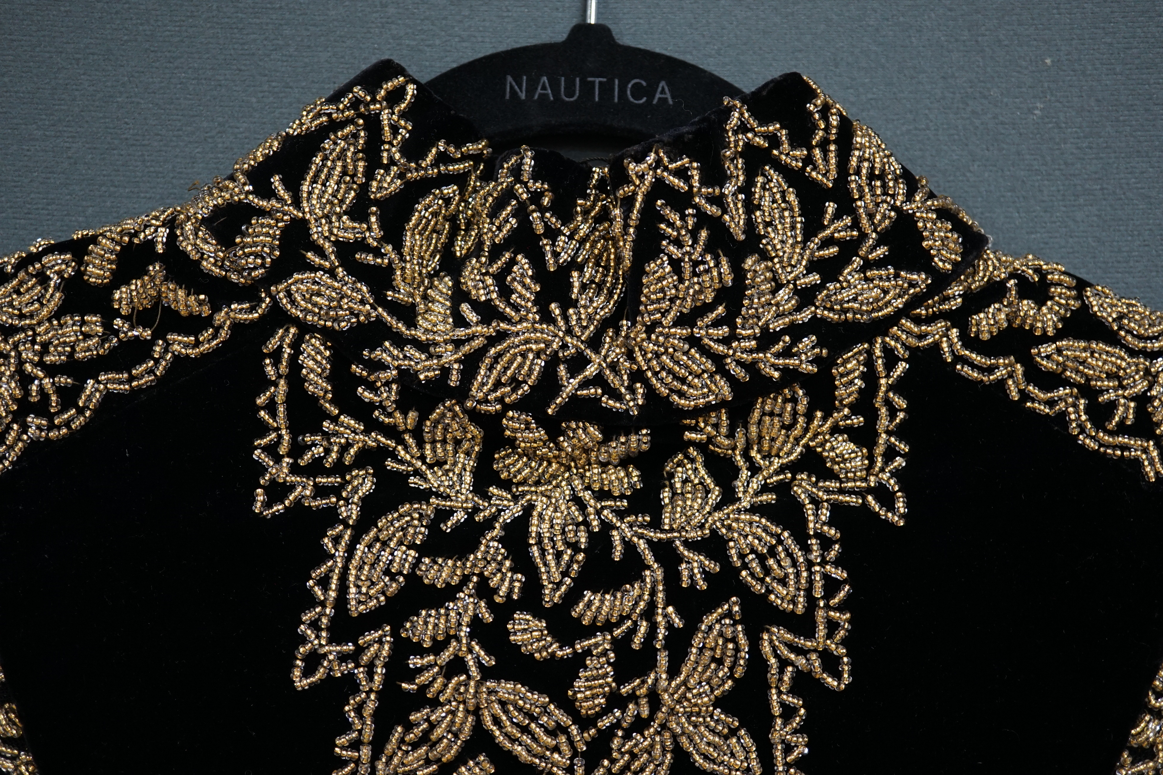 An Edwardian French black velvet and elaborately beaded evening over collar, with makers label, ‘Fillet’, designed with a high collar, front and back panels, all heavily bead worked in an intricate floral design, attache